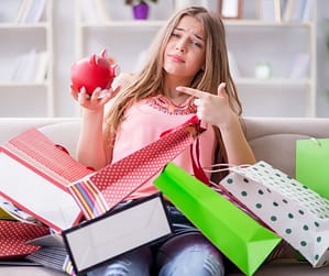 Person surrounded by unopened packages representing spending addiction