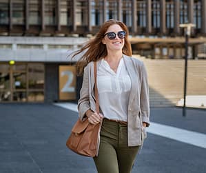 Professional woman walking near an office building, job loss did to her mind reset, layoff recovery, rebuild confidence, career restart after job loss.