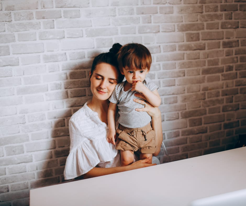 Single parent and child bonding together at the kitchen table at night, showing the Effects of Single Parenting on a Child and what helps