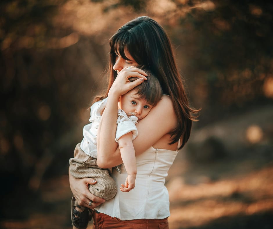 Single mom burnout—tired mother carrying her son, soft environment to calm mind.