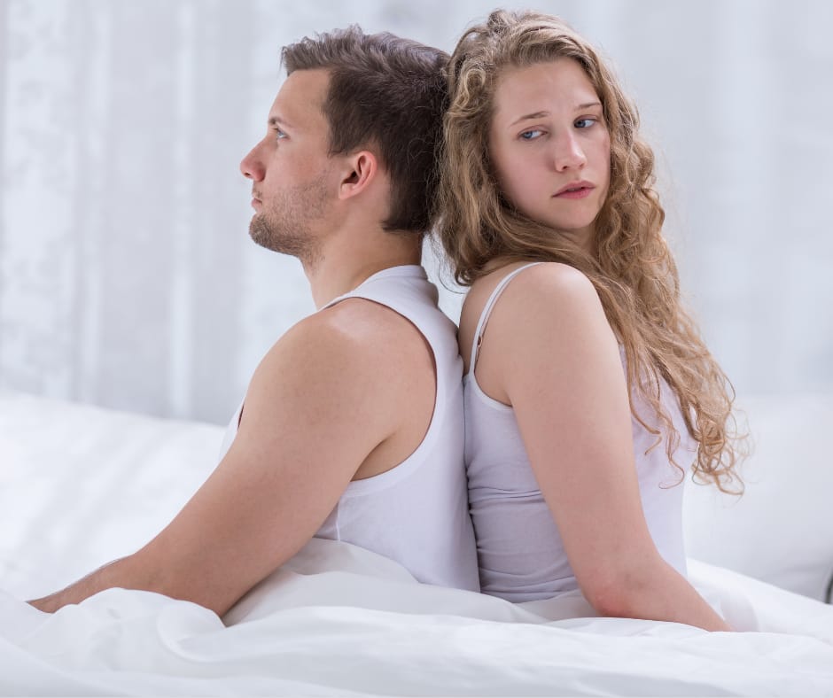 Couple sitting back-to-back at night, showing why marriages quietly die over time.